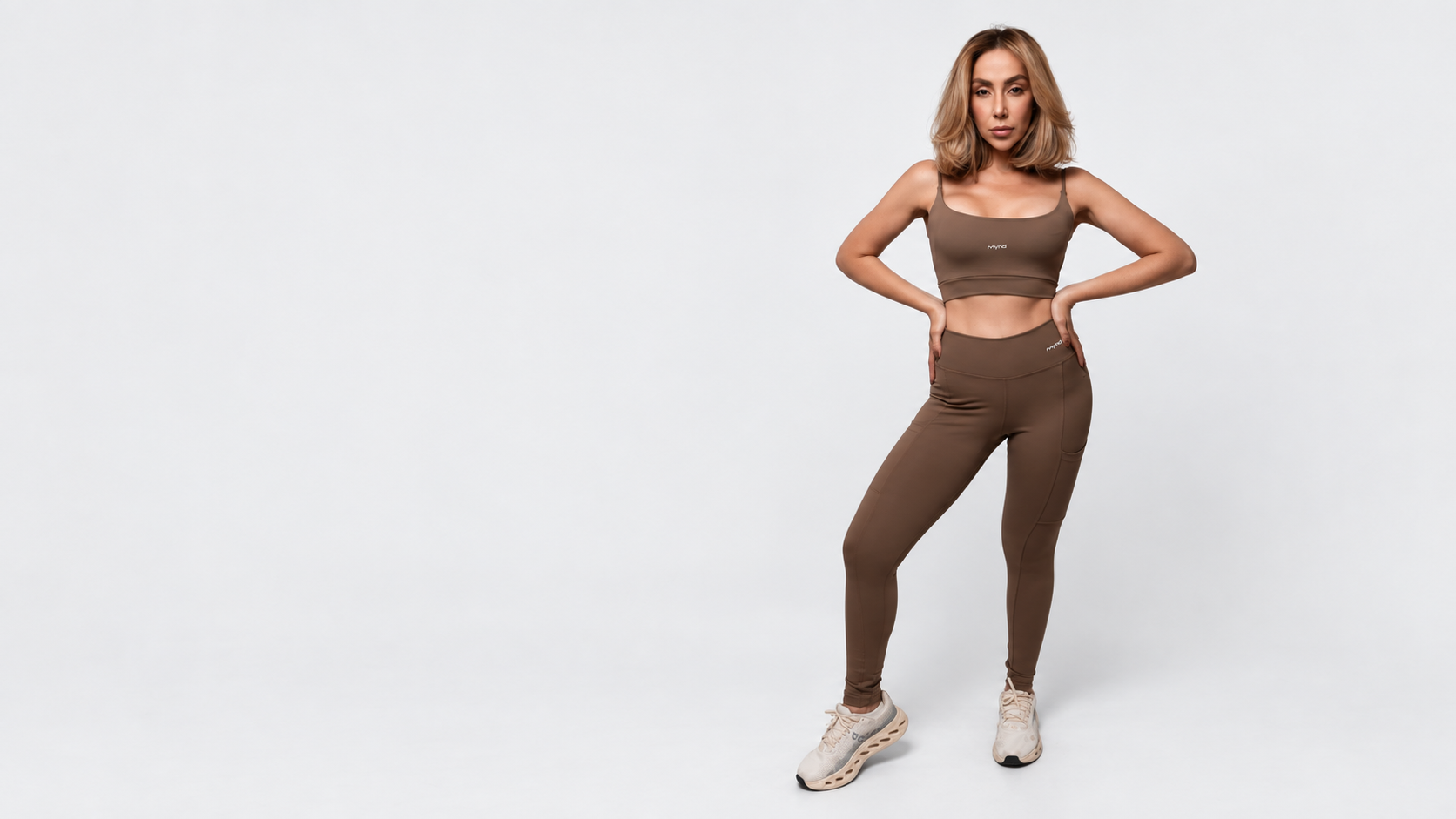 Modelo com Top Sofia e legging Mynd marrom em estúdio cinza claro